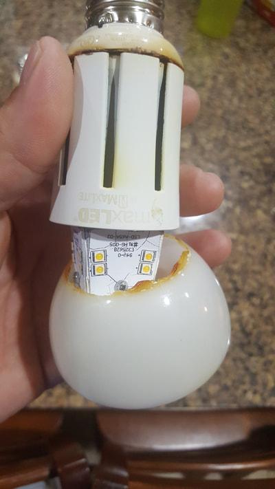 Common lighting mistake picture of non enclosed-rated lamp used in enclosed fixture